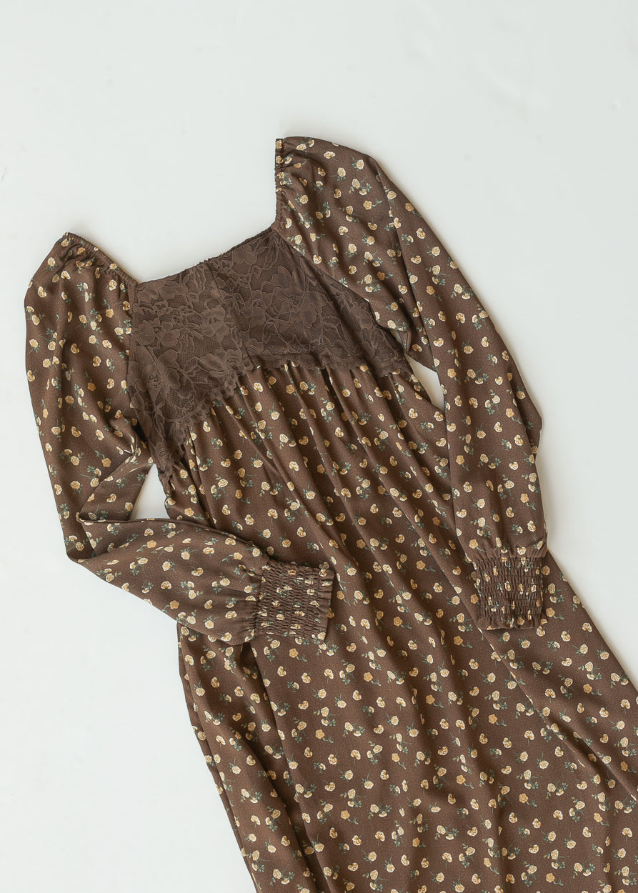 Flat lay of the Elise brown floral maxi dress showing the lace bodice, square neckline, and smocked cuffs.