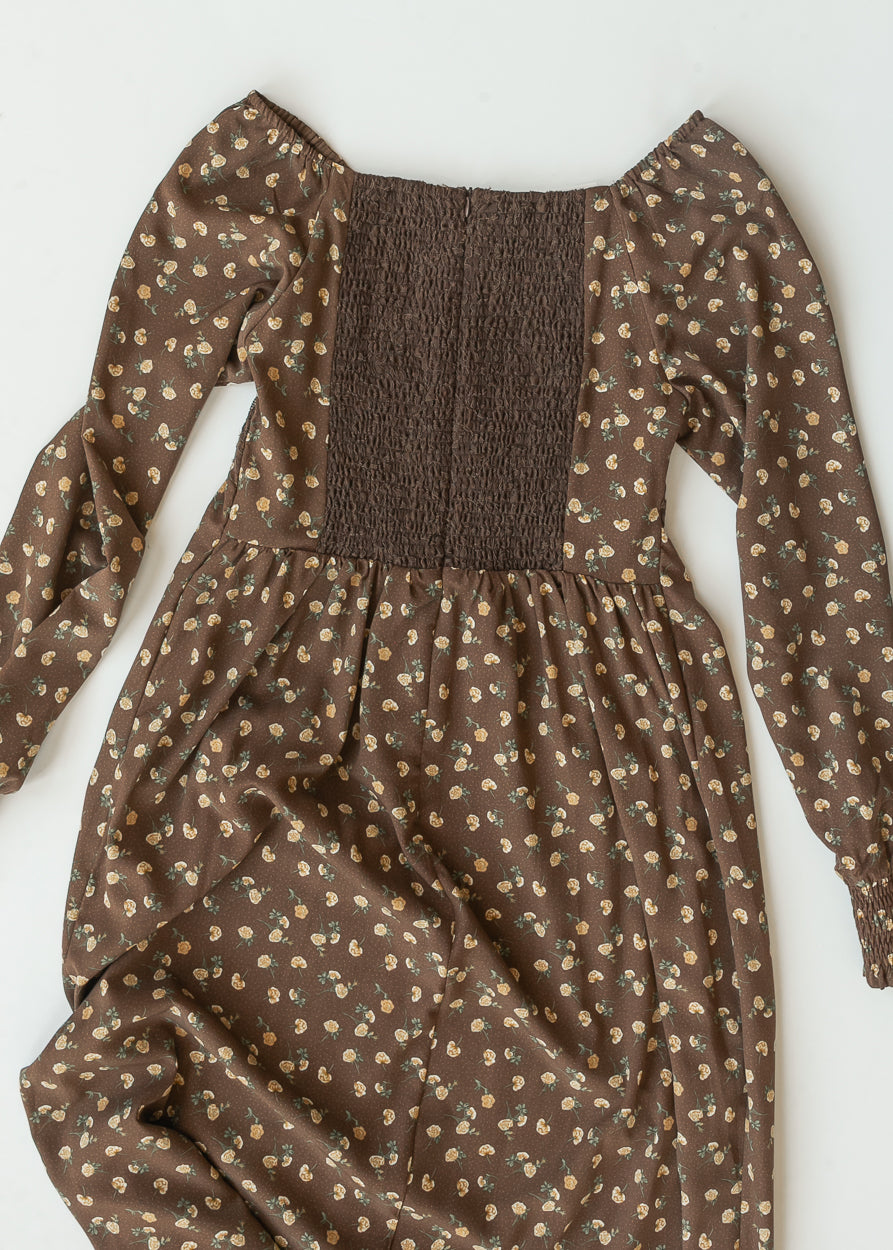 Flat lay of the Elise maxi dress back showing the smocked bodice, long floral sleeves, and gathered skirt.