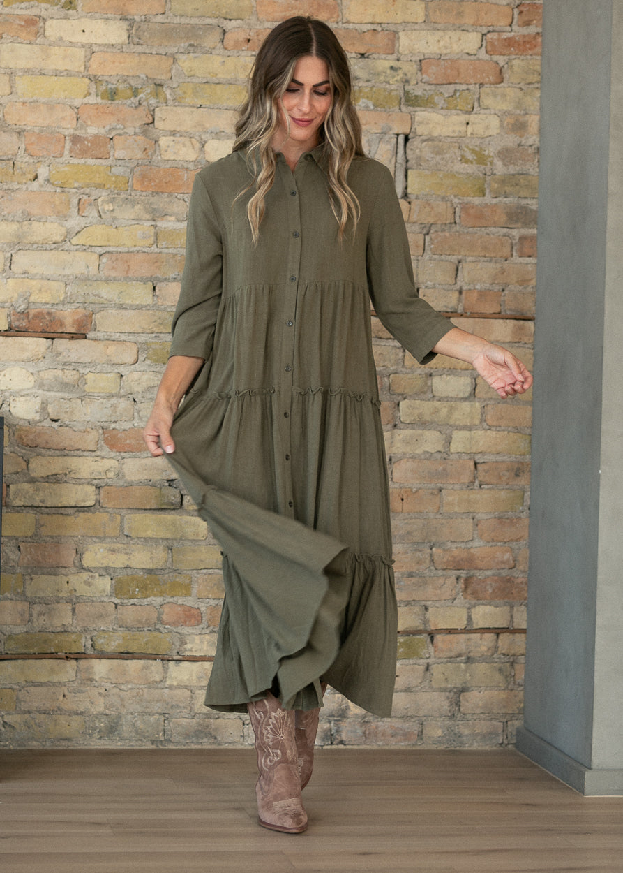 Olive Elsie midi dress with V-neck, half sleeves, and tiered calf-length skirt.
