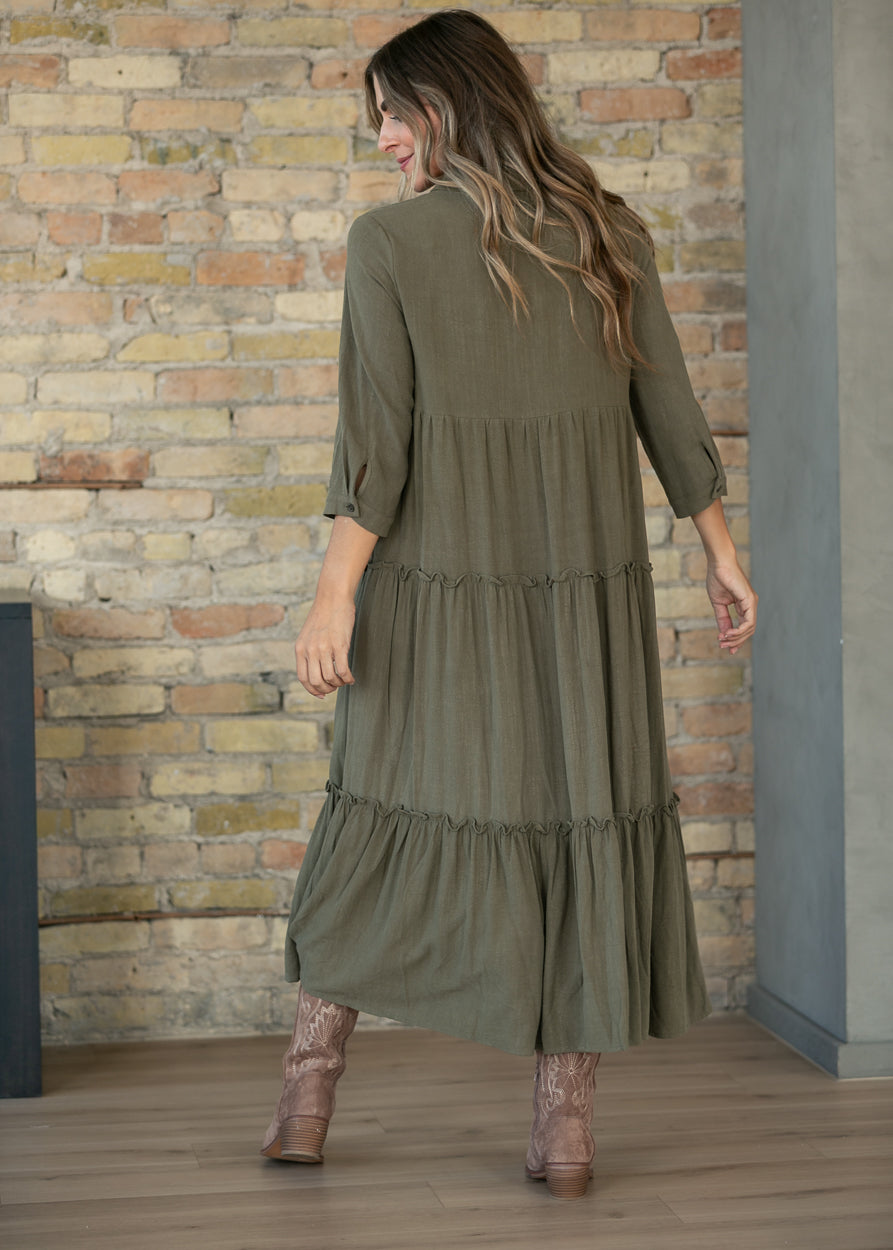 Back of olive Elsie midi dress showing the tiered skirt and calf-length hem.