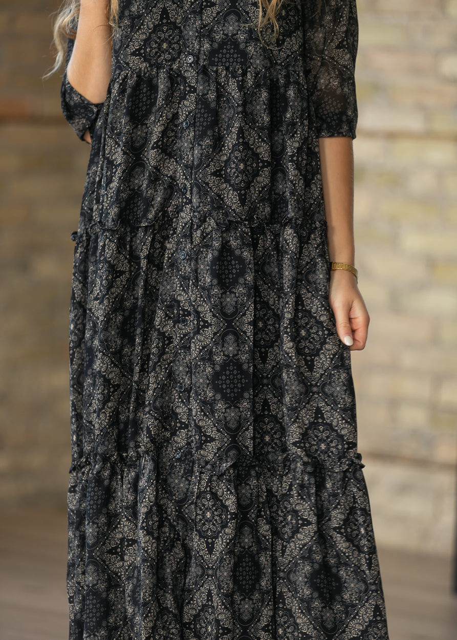 Side view of black and cream Elsie dress showing the half sleeve and A-line silhouette.