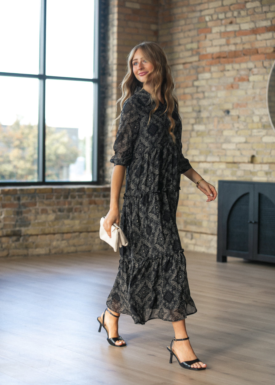 Elsie paisley midi dress in motion showing the flow of the tiered A-line skirt.