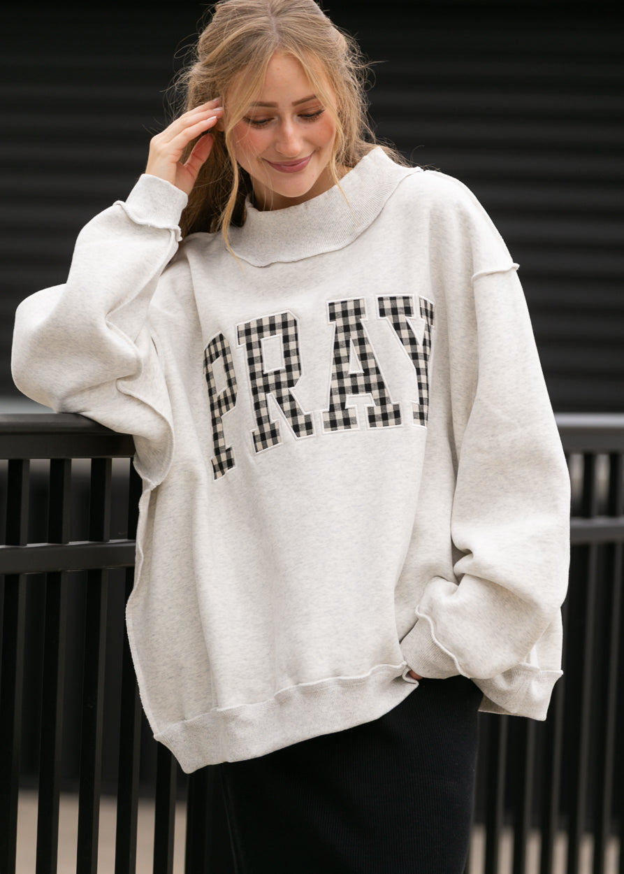 Oatmeal oversized mockneck sweatshirt with gingham Pray lettering and relaxed dropped shoulders.