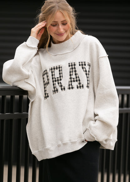 Oatmeal oversized mockneck sweatshirt with gingham Pray lettering and relaxed dropped shoulders.
