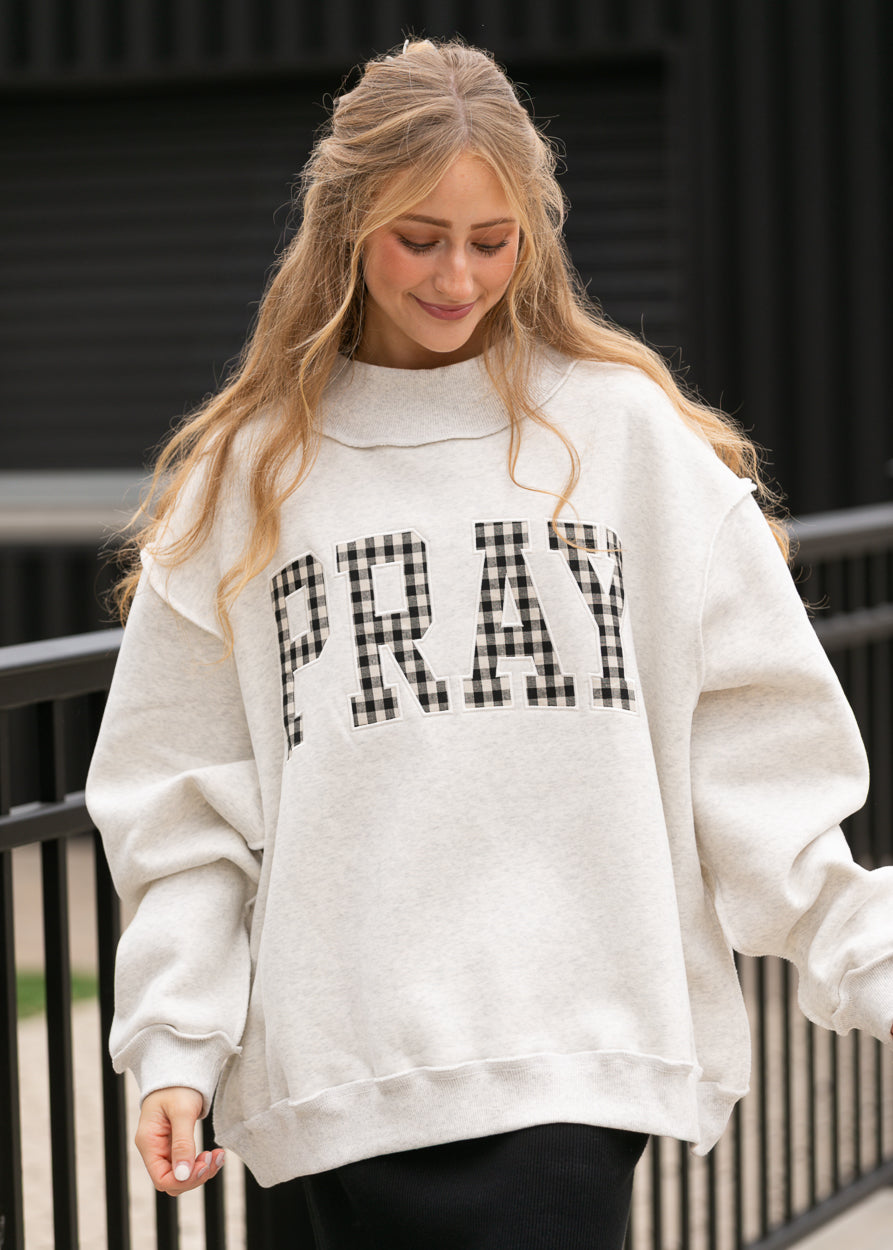 Oatmeal mockneck sweatshirt with oversized fit and black-and-white gingham Pray lettering.