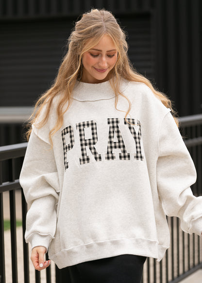 Oatmeal mockneck sweatshirt with oversized fit and black-and-white gingham Pray lettering.