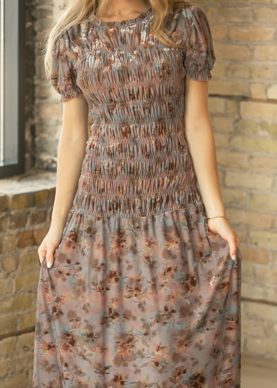 Muted mauve floral maxi dress with velvet embossing, smocked bodice, puff sleeves, and flowing skirt.