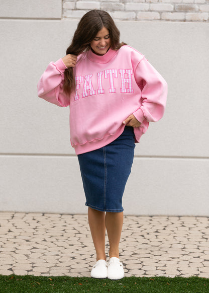 bright pink mockneck sweatshirt showing gingham Faith lettering and ribbed neckline.