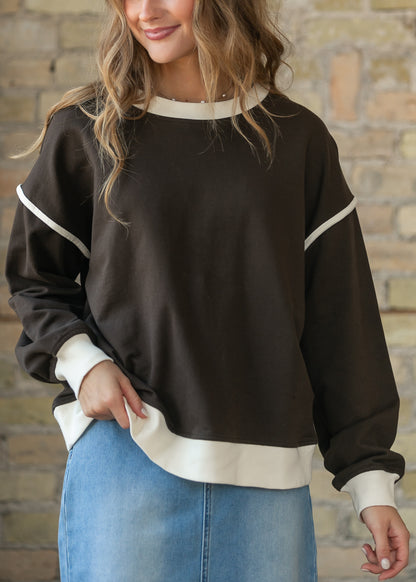 Espresso drop shoulder sweater with cream crew neckline, cuffs, hem, and sleeve trim.