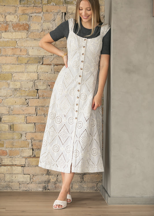Cream embroidered eyelet maxi dress layered with a white denim jacket