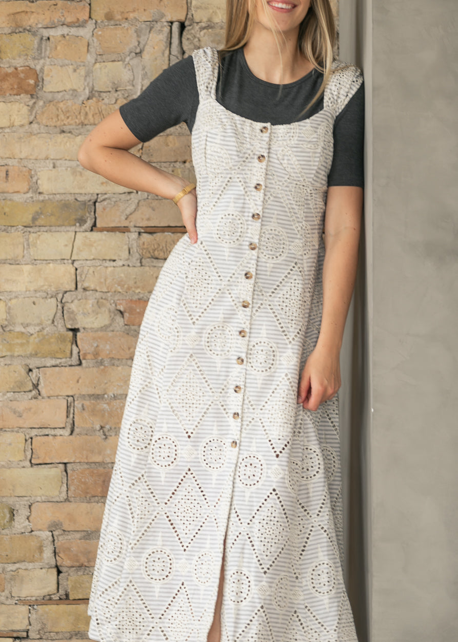 Cream embroidered eyelet maxi dress layered with a white denim jacket