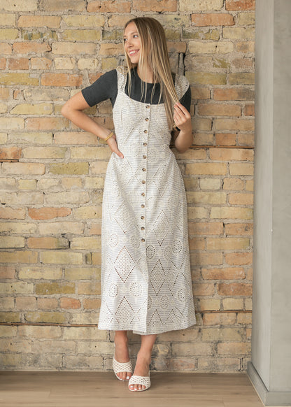 Side view of cream striped maxi dress with eyelet embroidery