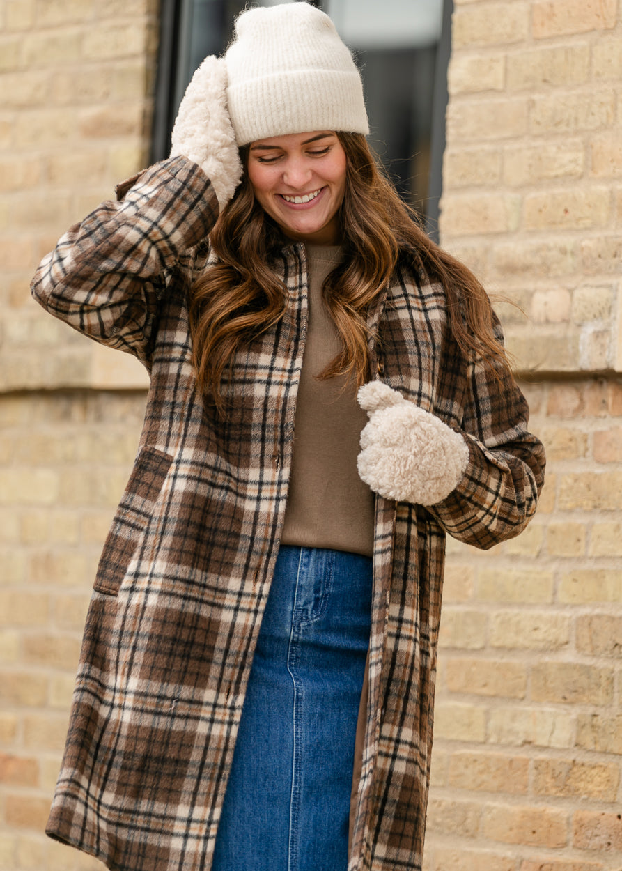 Ivory ribbed beanie with wide cuff, styled with a long plaid coat and denim skirt.
