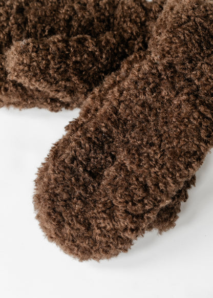 Close-up of plush brown faux shearling mitten texture.