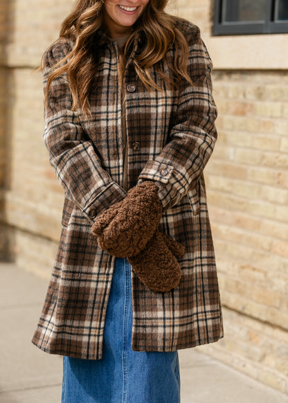 Brown curly faux shearling mittens styled with a brown plaid coat and denim skirt.