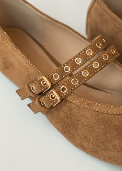 Close-up of Corkys faux suede double straps with gold-tone buckles and eyelet details.