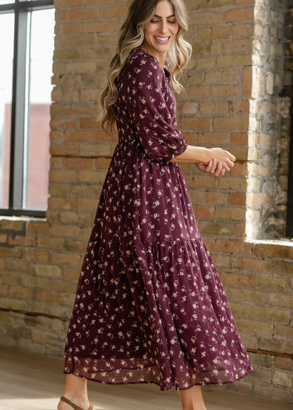 Side view of burgundy floral midi dress with three-quarter sleeves and tiered skirt.