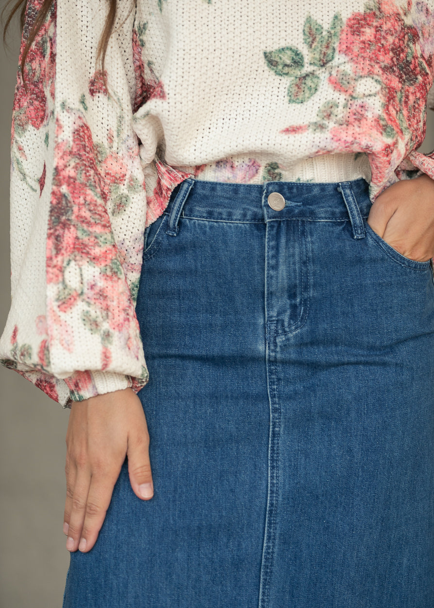 Close-up of Elisha denim maxi skirt front waist with button closure and classic denim seaming.