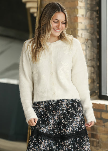 Ivory floral embroidered cardigan styled with a black floral maxi skirt.