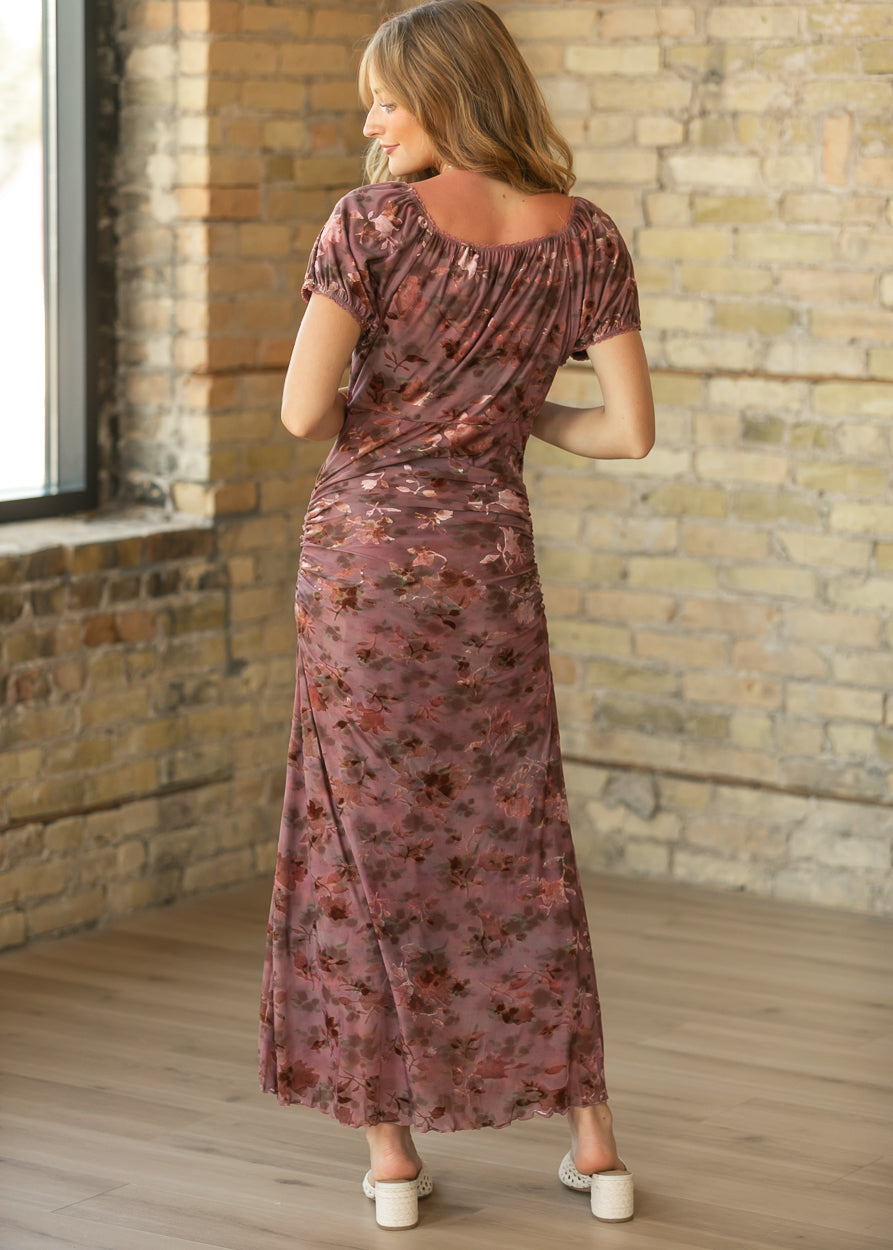 Back of vintage rust floral mesh midi dress showing gathered neckline, short sleeves, and flowing skirt.