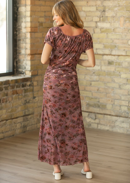 Back of vintage rust floral mesh midi dress showing gathered neckline, short sleeves, and flowing skirt.