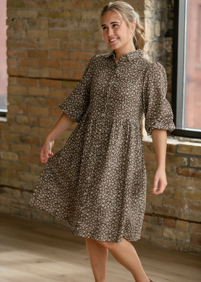 Brown floral knee-length dress styled with brown flats for an easy everyday look.