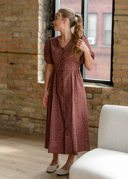 Brown and cream floral midi dress with V-neckline, button front, and semi-fitted silhouette.