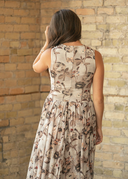 Back of neutral floral sleeveless maxi dress showing the fitted bodice and center back zipper.
