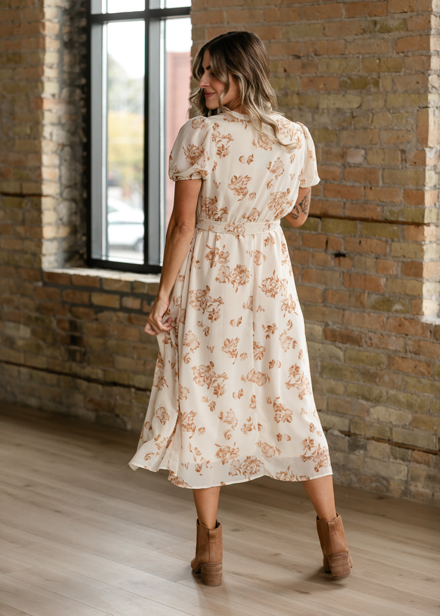 Cream and taupe floral midi dress with tied waist and softly flowing silhouette.
