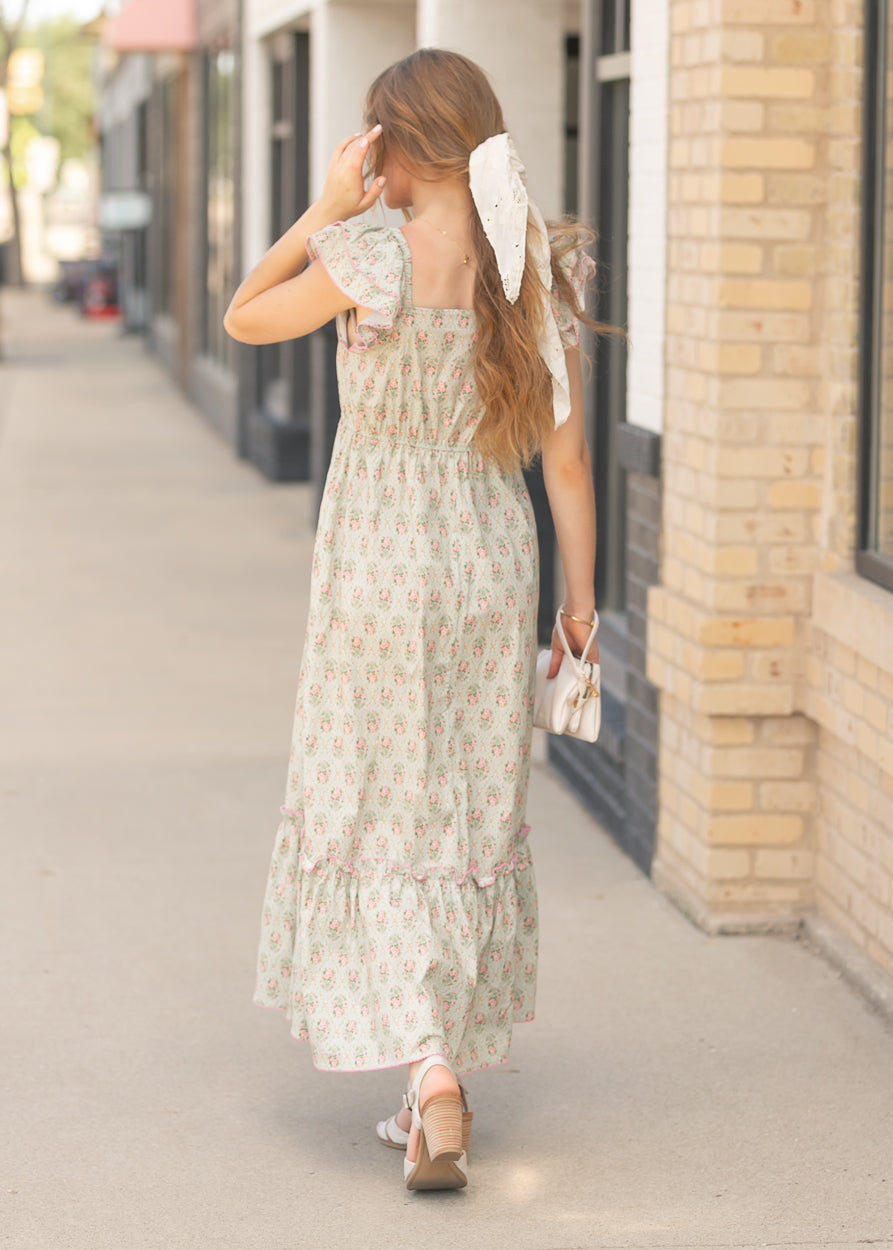 Back view of floral maxi dress with flutter sleeves