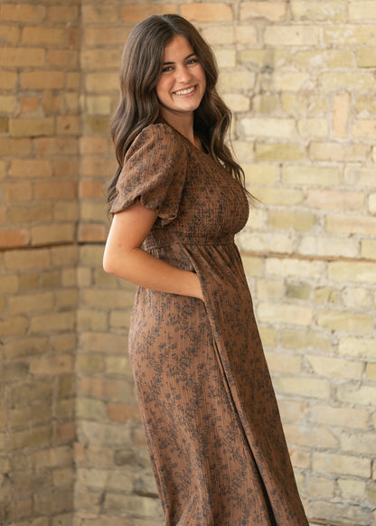Brown floral midi dress from the side showing smocked bodice, puff sleeves, and side pocket.
