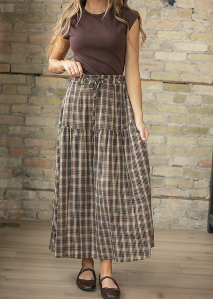 Brown plaid maxi skirt with drawstring waist, tiered silhouette, and ankle-length hem.