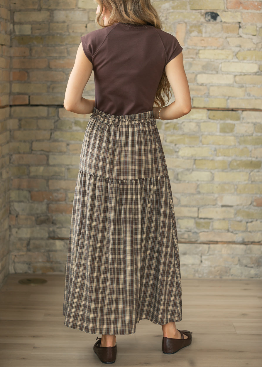 Back of brown plaid maxi skirt showing the gathered waist and full ankle-length silhouette.