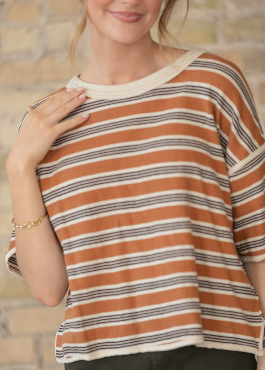 Close view of rust brown and cream striped cotton tee