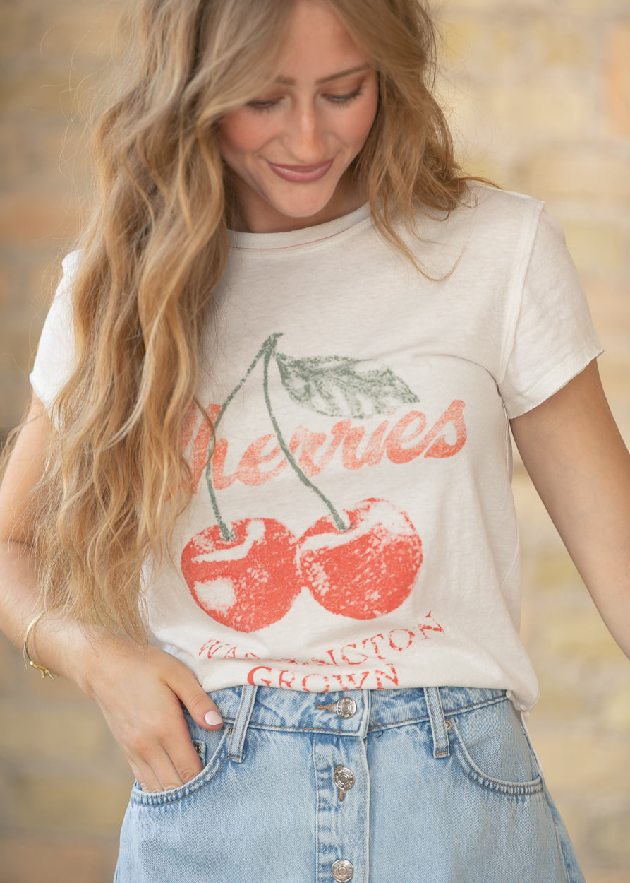 Close up of cherry graphic print on cream Free People tee