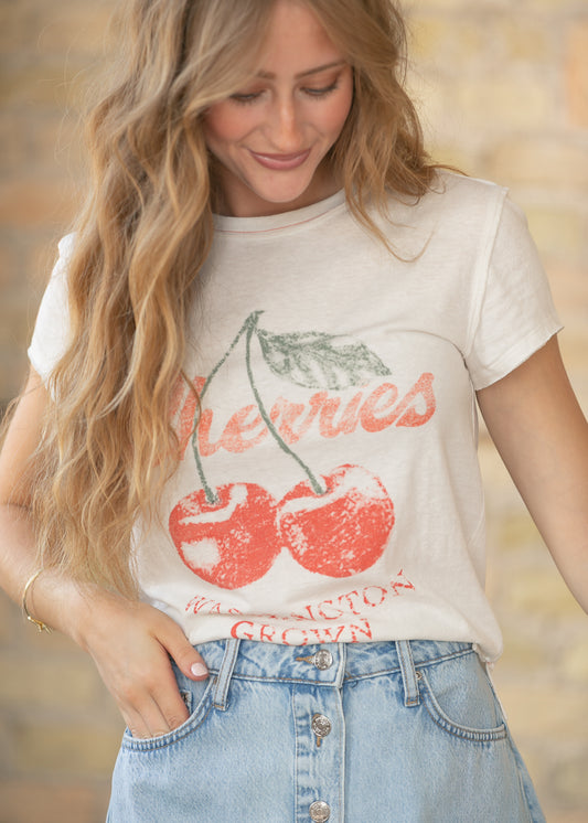 Close up of cherry graphic print on cream Free People tee