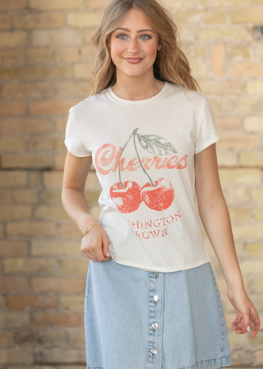 Close up of cherry graphic print on cream Free People tee