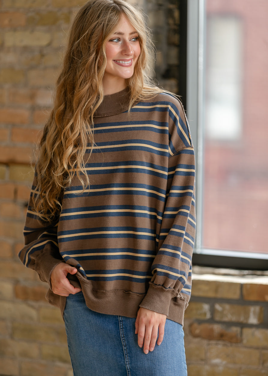 Brown, navy, and cream striped pullover styled with a denim skirt for an easy everyday outfit.