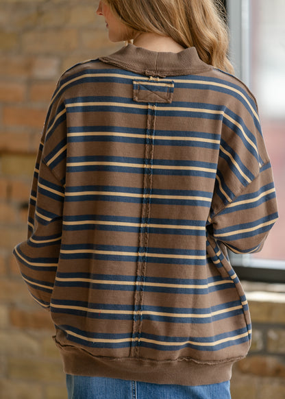 Free People Palm Spring striped top with oversized fit, wide ribbed neckline, and long sleeves.