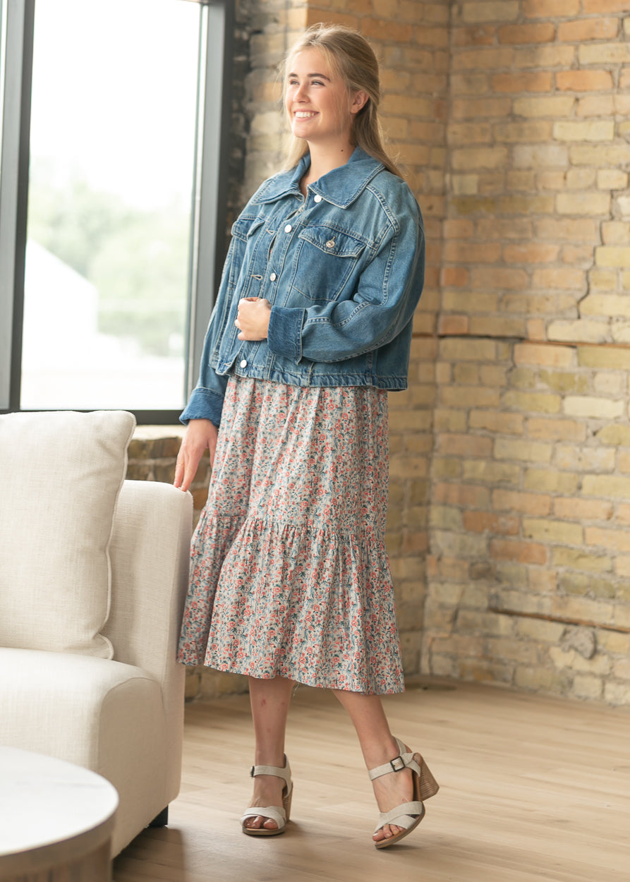 Relaxed fit denim jacket in River Wash styled with a floral dress and heeled sandals