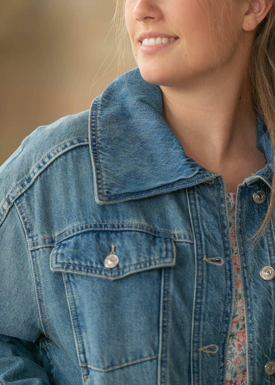 Close-up of River Wash denim jacket showing oversized collar and front pocket detail