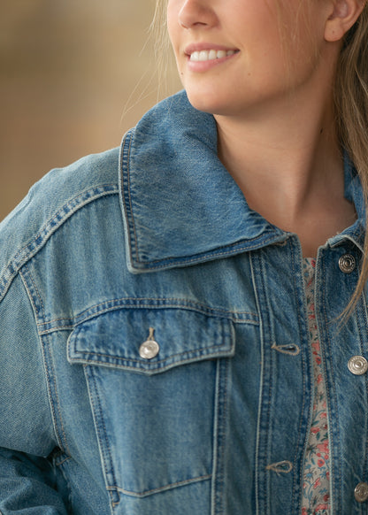 Close-up of River Wash denim jacket showing oversized collar and front pocket detail