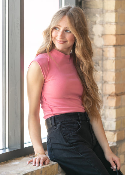 Side view of fitted strawberry pink ribbed tee with exposed seam accents