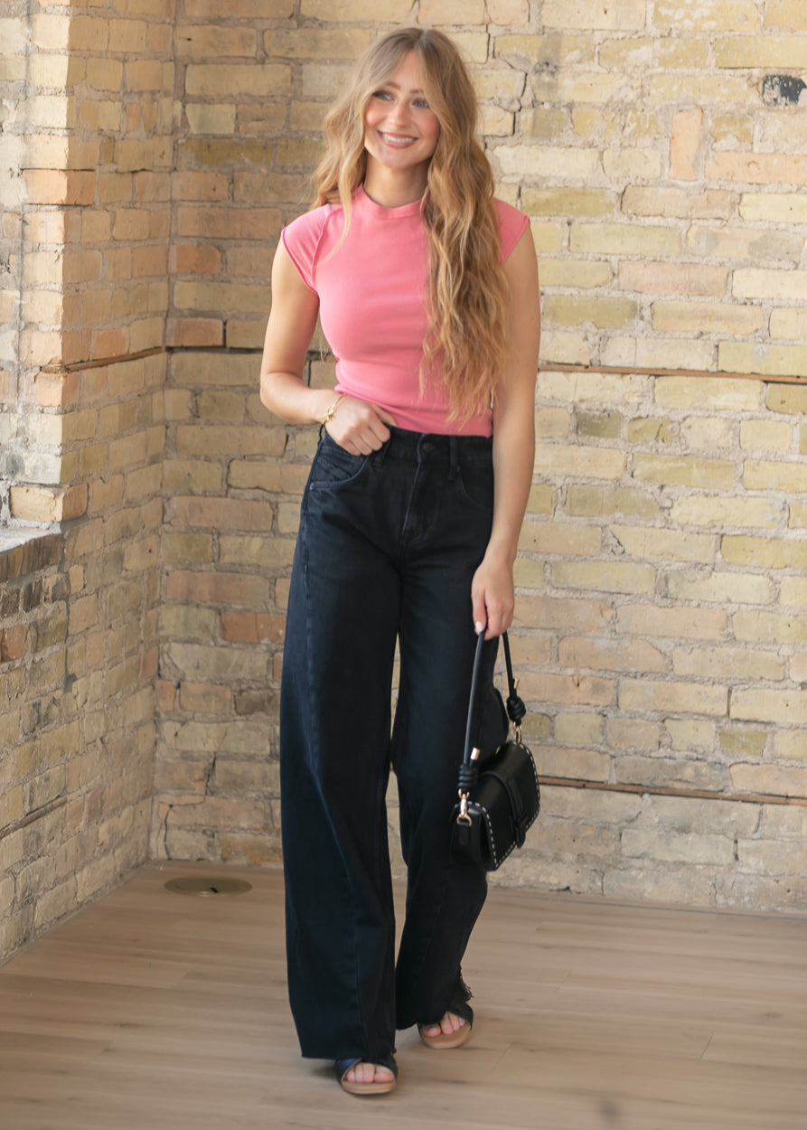 Full length black boyfriend jeans with raw hem detail and relaxed silhouette