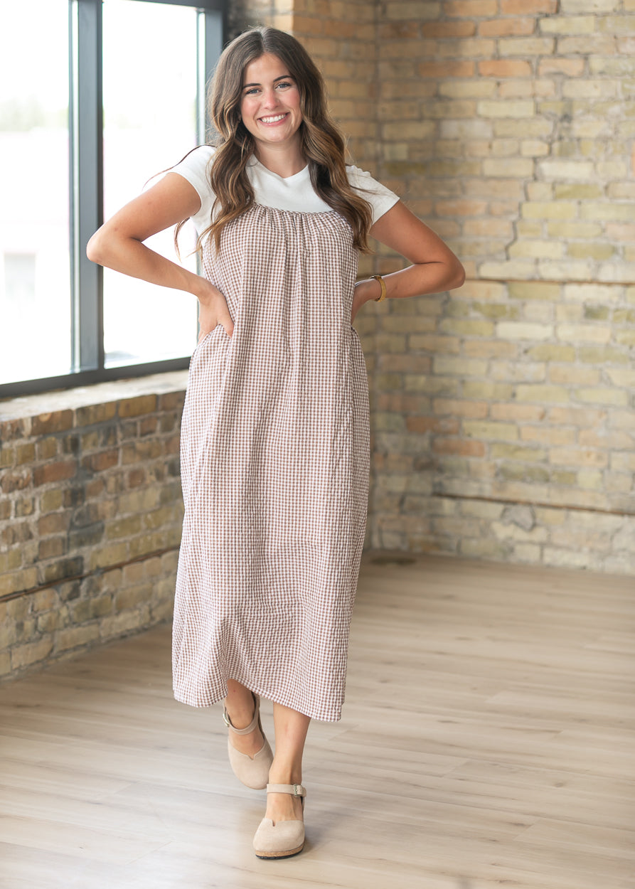 Modest taupe gingham midi dress with a relaxed silhouette and adjustable straps for everyday wear.