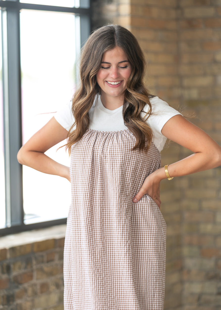 Close-up of the taupe gingham cami dress featuring soft gathers and adjustable shoulder straps.