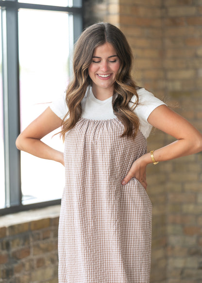 Close-up of the taupe gingham cami dress featuring soft gathers and adjustable shoulder straps.