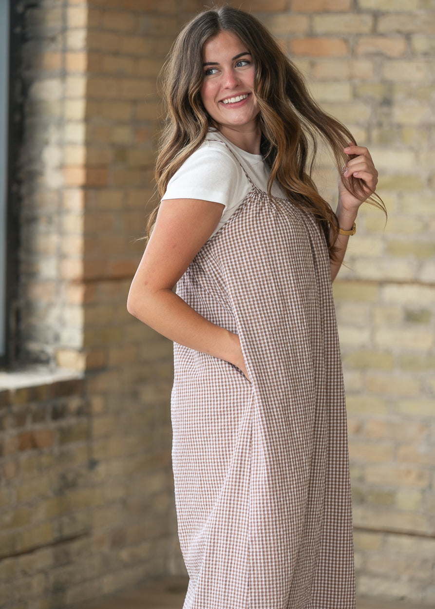 Taupe gingham sleeveless midi dress with side pockets and an easy flowing fit.