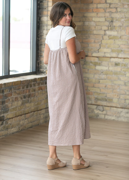 Back of the taupe gingham midi dress with adjustable straps and a gathered back neckline.
