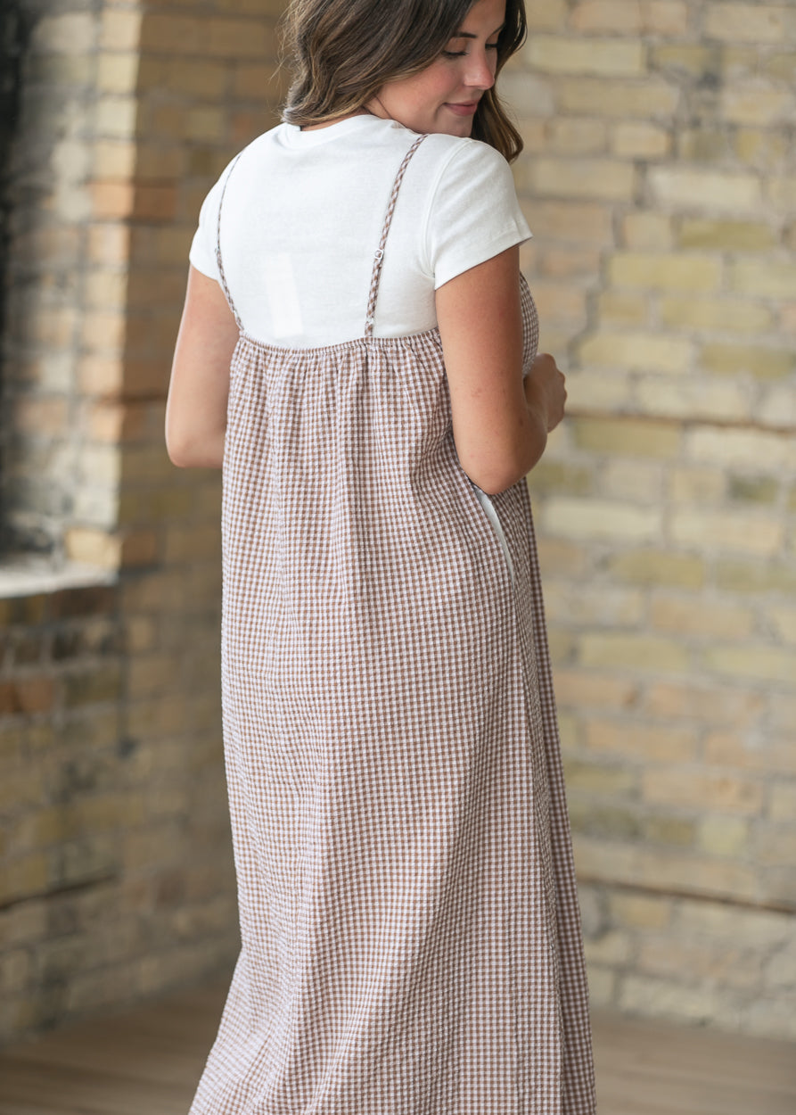Back of the taupe gingham midi dress with adjustable straps and a gathered back neckline.